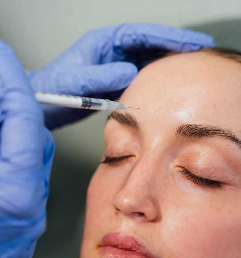 Woman getting botox, closing her eyes - Botox in New York, NY